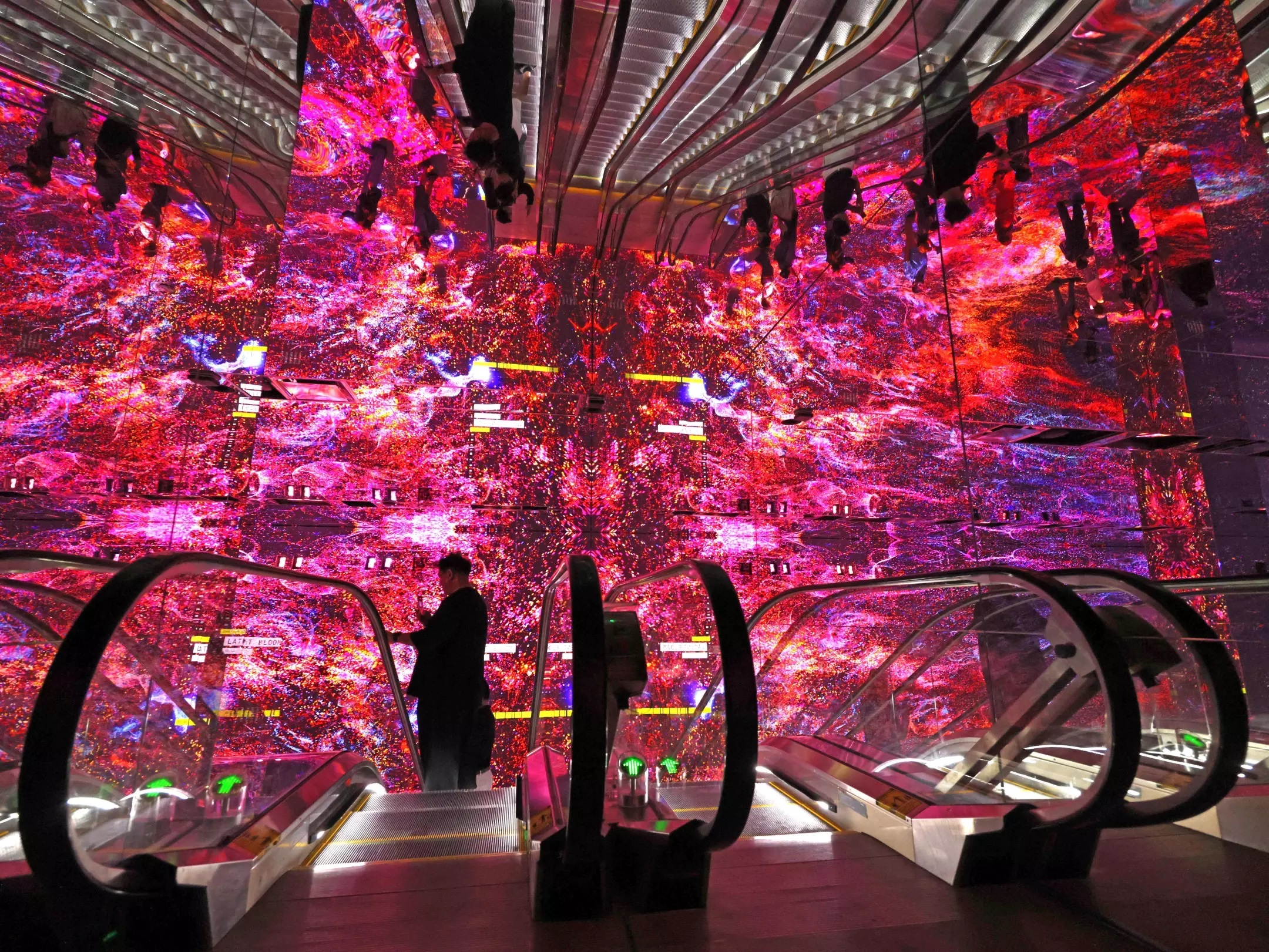 A visitor takes the escalator down to the first portal at Dataland. (Genaro Molina / Los Angeles Times)