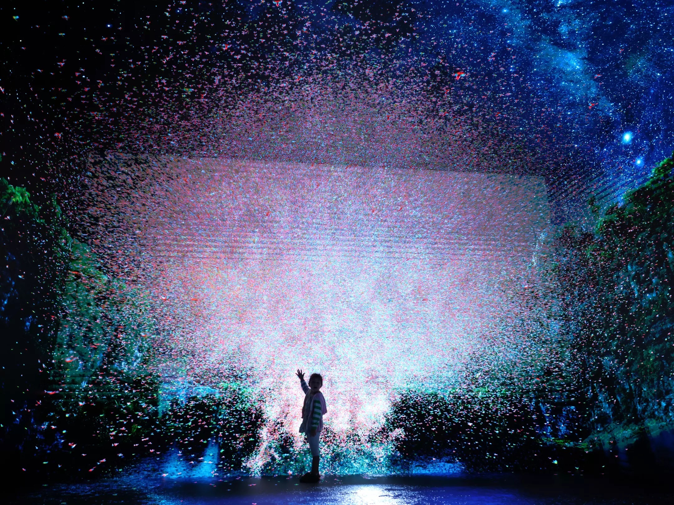 A child watches as an explosion of imagery happens before her in the Infinity room. (Genaro Molina / Los Angeles Times)