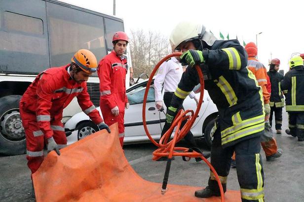 امدادرسانی آتش‌نشانان به مصدوم سانحه برخورد ۲۰۶ با اتوبوس در مشهد+تصاویر