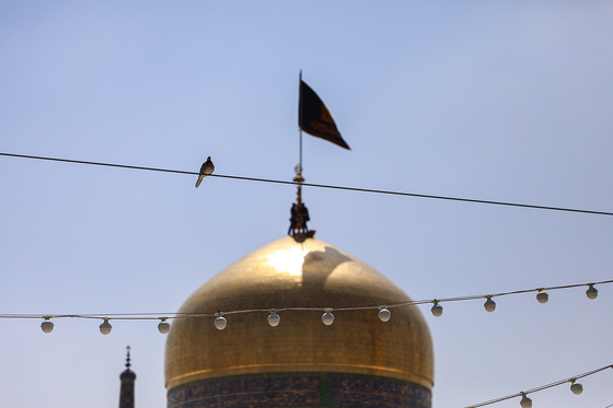 تعویض پرچم گنبد مطهر رضوی به احترام شهادت رئیس جمهور و هیات همراه
